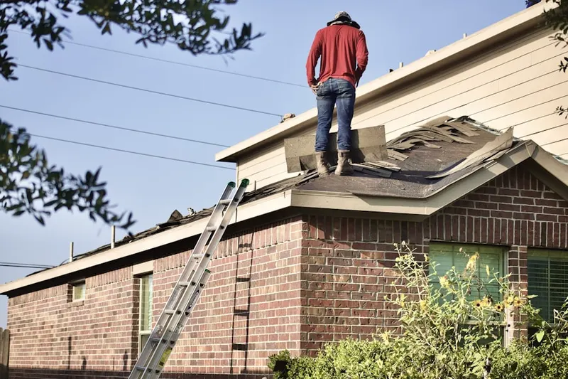 Professional roofer working on a residential roof in Bay Towne